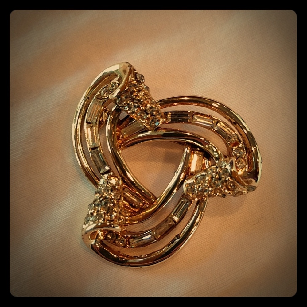 Gold colored brooch
